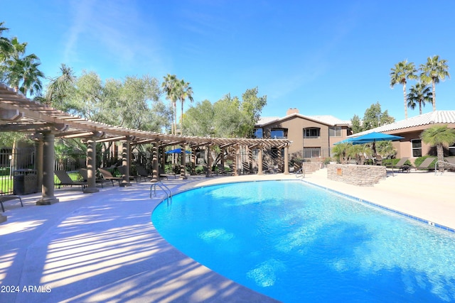 view of swimming pool featuring a patio area and a pergola