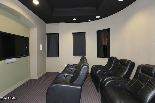 carpeted home theater with ornamental molding