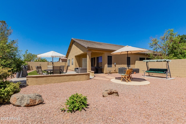 back of house with a patio area and central air condition unit