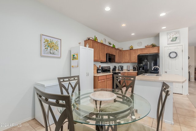 dining space with sink and light tile patterned floors