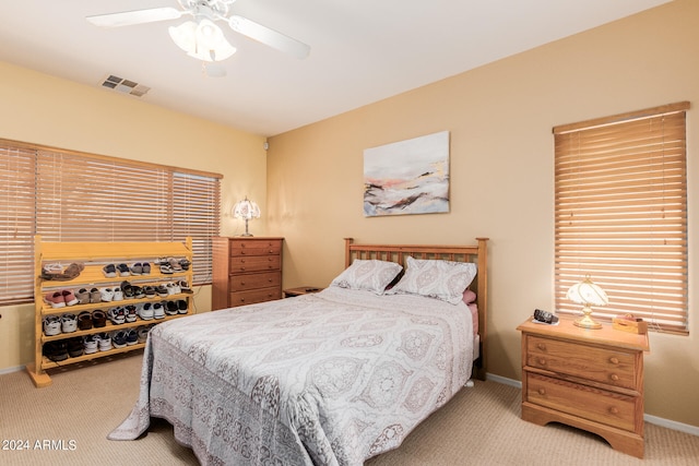 bedroom with light colored carpet and ceiling fan