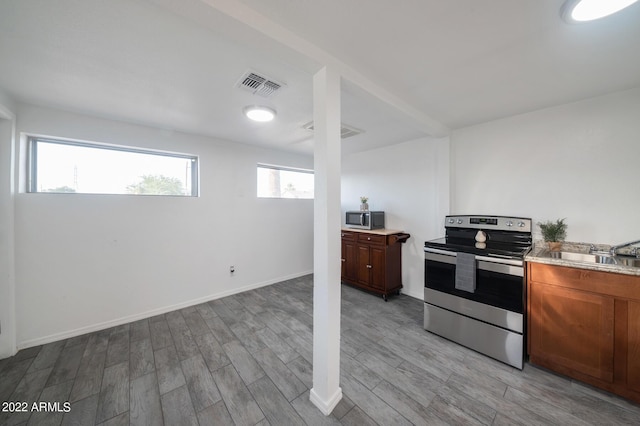 kitchen featuring light wood-type flooring, sink, and stainless steel appliances