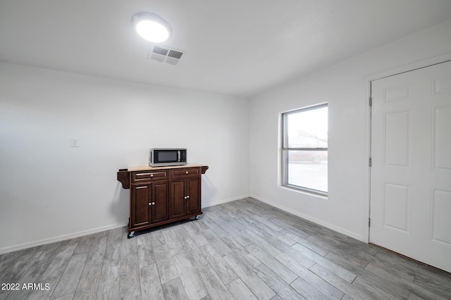 empty room with light hardwood / wood-style flooring