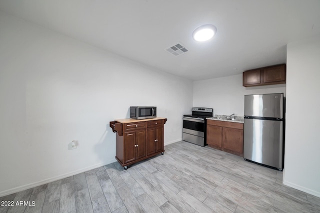 kitchen featuring stainless steel appliances and light wood-type flooring