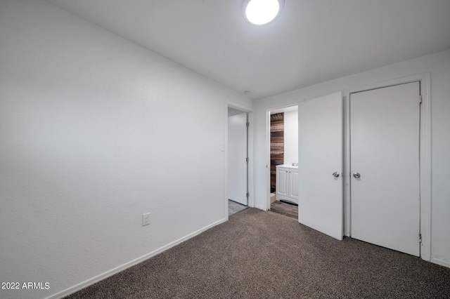 unfurnished bedroom featuring dark carpet