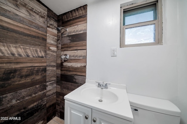 bathroom with toilet, vanity, walk in shower, and wooden walls