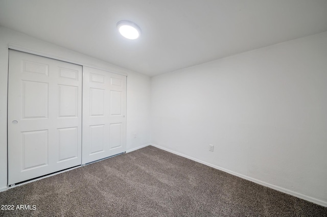 unfurnished bedroom with carpet and a closet