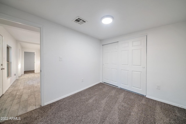 unfurnished bedroom featuring carpet floors and a closet