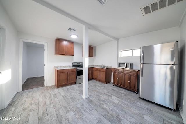 kitchen featuring light hardwood / wood-style floors and stainless steel appliances