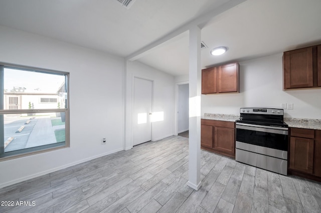 kitchen featuring electric stove, light wood-type flooring, and light stone countertops