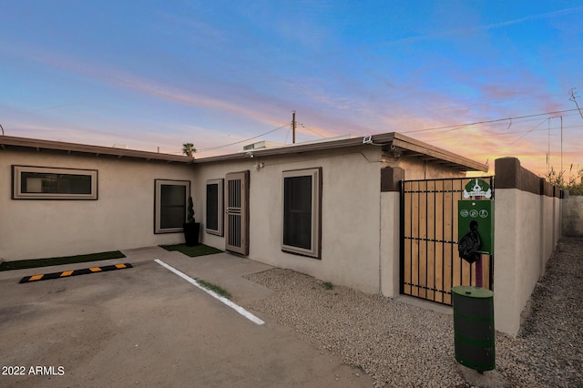 back house at dusk with a patio