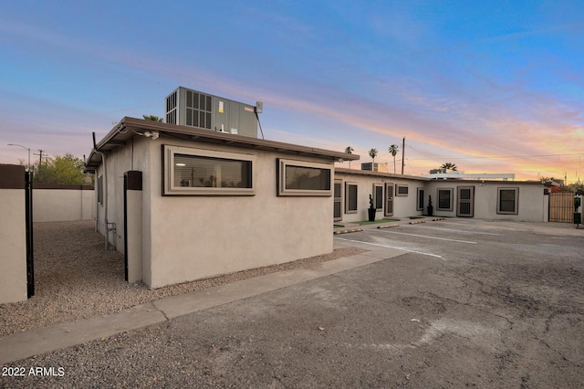 back house at dusk with a patio area