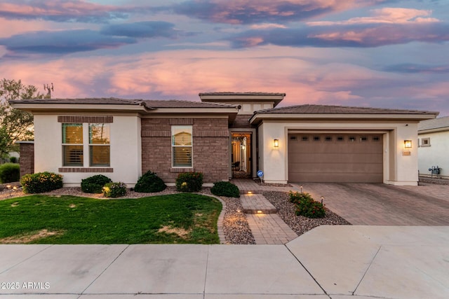 2052 E Scorpio Pl, Chandler, AZ 85249 - prairie-style home with an attached garage, decorative driveway, stucco siding, a front yard, and a tiled roof