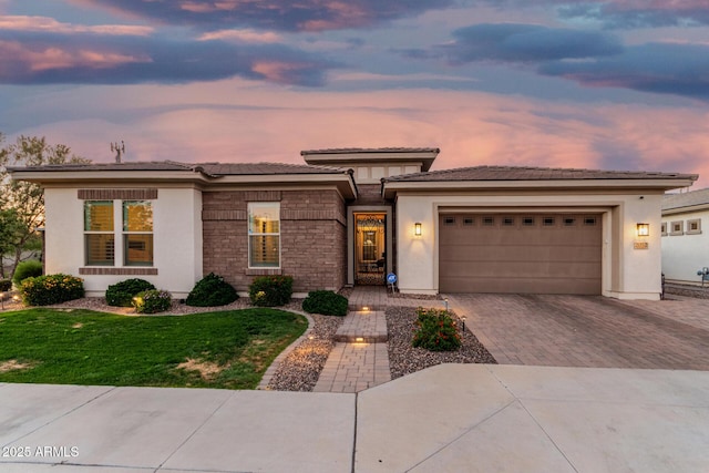 2052 E Scorpio Pl, Chandler, AZ 85249 - prairie-style home featuring decorative driveway, stucco siding, an attached garage, and a yard