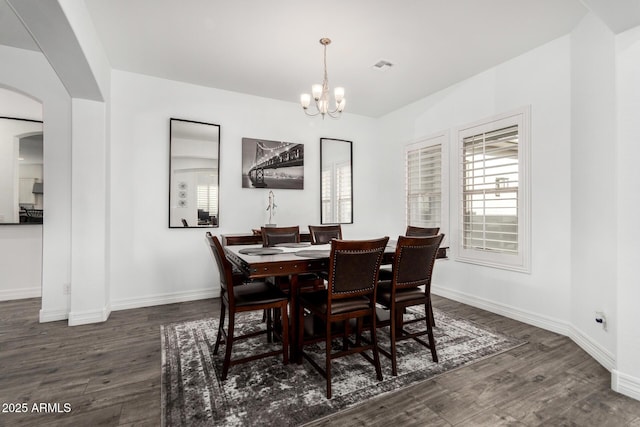 2052 E Scorpio Pl, Chandler, AZ 85249 - dining area with arched walkways, wood finished floors, a chandelier, and baseboards