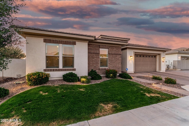 2052 E Scorpio Pl, Chandler, AZ 85249 - view of front of house featuring stucco siding, driveway, an attached garage, stone siding, and a tiled roof