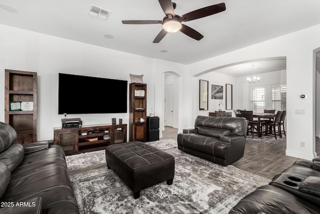 2052 E Scorpio Pl, Chandler, AZ 85249 - living area featuring arched walkways, ceiling fan, a chandelier, wood finished floors, and baseboards