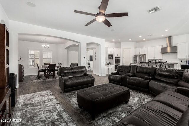2052 E Scorpio Pl, Chandler, AZ 85249 - living area featuring arched walkways, a ceiling fan, baseboards, a chandelier, and dark wood-style floors