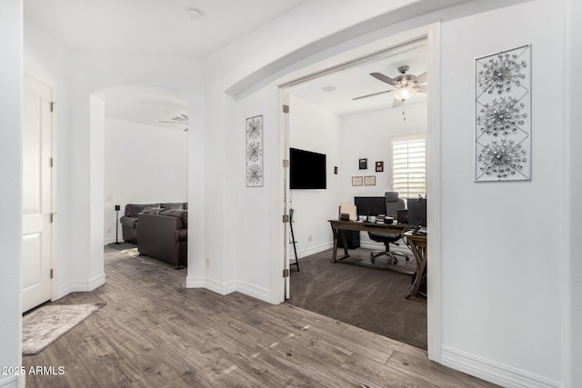 2052 E Scorpio Pl, Chandler, AZ 85249 - home office with arched walkways, ceiling fan, wood finished floors, and baseboards
