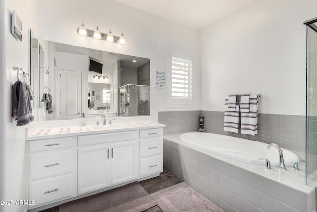 2052 E Scorpio Pl, Chandler, AZ 85249 - bathroom with a stall shower, vanity, a garden tub, and wood finished floors