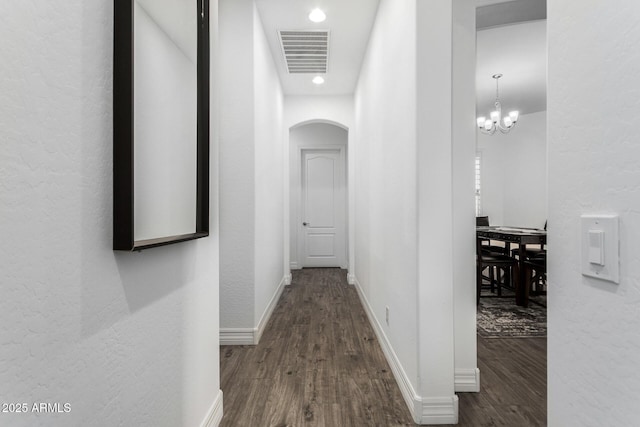2052 E Scorpio Pl, Chandler, AZ 85249 - hallway featuring arched walkways, wood finished floors, a chandelier, baseboards, and recessed lighting