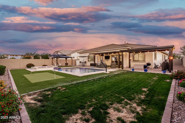2052 E Scorpio Pl, Chandler, AZ 85249 - rear view of house with a gazebo, a putting green, a patio area, and stucco siding