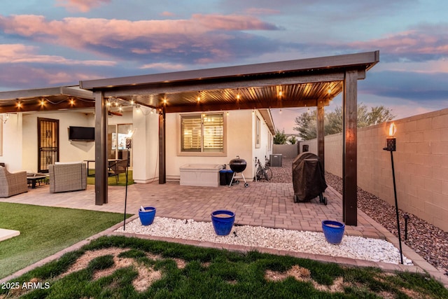 2052 E Scorpio Pl, Chandler, AZ 85249 - patio terrace at dusk with a grill, a patio area, a fenced backyard, an outdoor hangout area, and central air condition unit