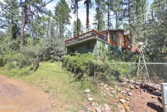 exterior space featuring a yard, board and batten siding, and fence