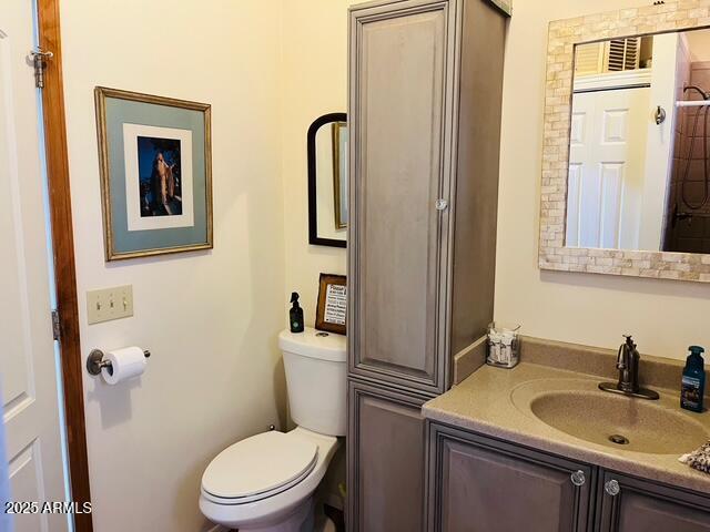 bathroom featuring toilet and vanity