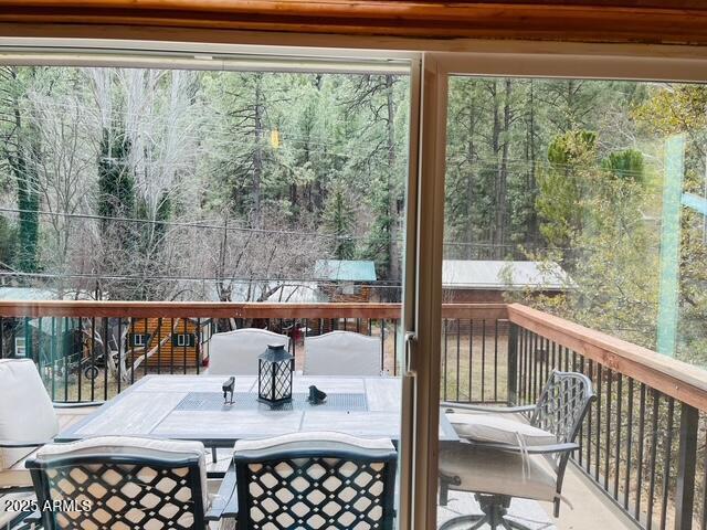 wooden deck featuring outdoor dining area