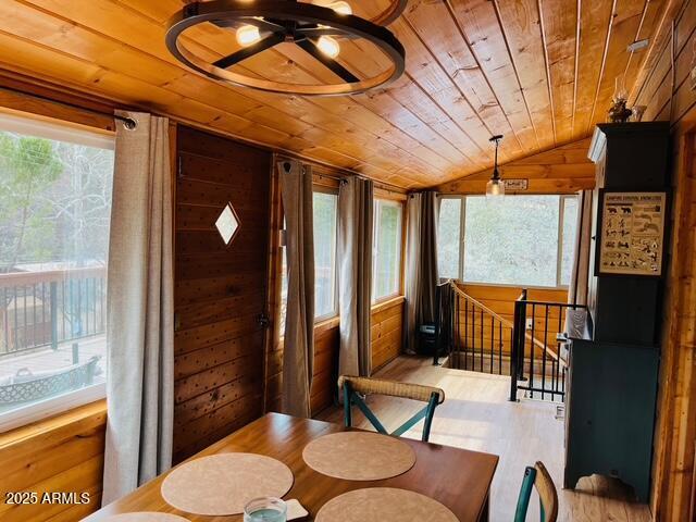 sunroom with wooden ceiling and vaulted ceiling