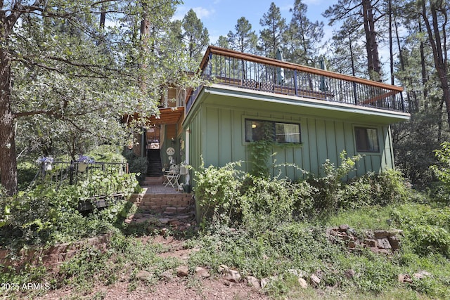 exterior space with a balcony and board and batten siding