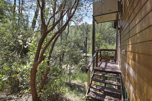 wooden deck featuring a view of trees