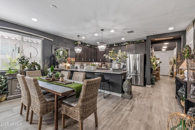 dining space featuring light wood-type flooring, visible vents, and recessed lighting