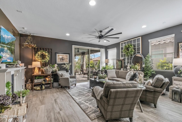 living area with light wood finished floors, recessed lighting, and a ceiling fan