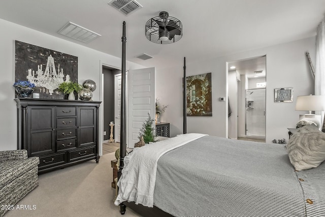 bedroom with light carpet, visible vents, and ensuite bath