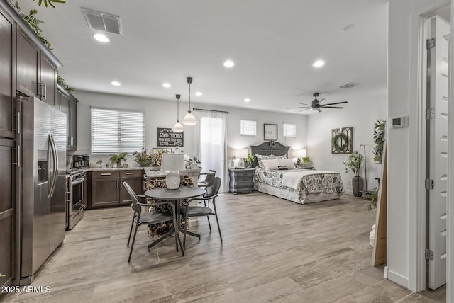 interior space with stainless steel refrigerator with ice dispenser, recessed lighting, visible vents, and light wood finished floors