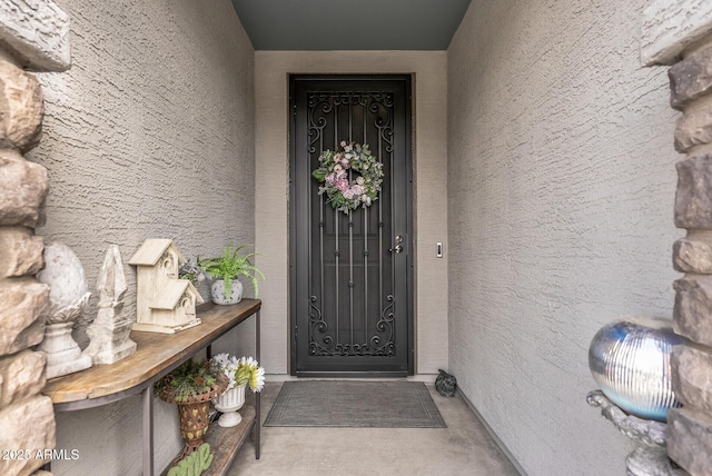 entrance to property featuring stucco siding