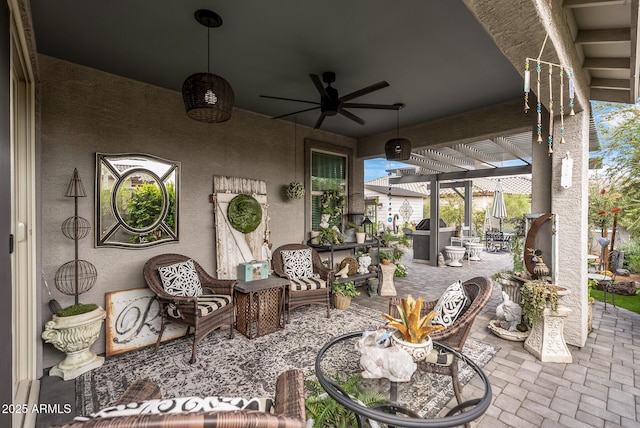 view of patio / terrace featuring an outdoor living space, a ceiling fan, and a pergola