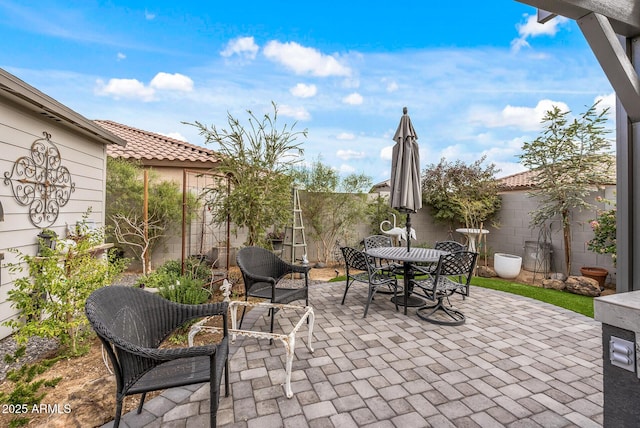 view of patio / terrace with outdoor dining space and a fenced backyard