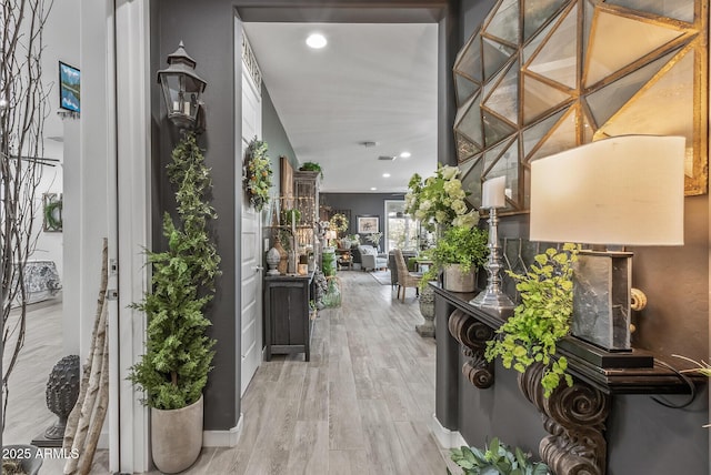 hall with recessed lighting and wood finished floors