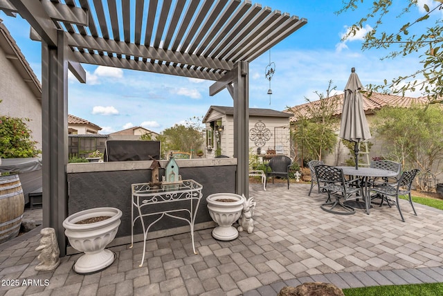 view of patio / terrace with outdoor dining area, a fenced backyard, and a pergola