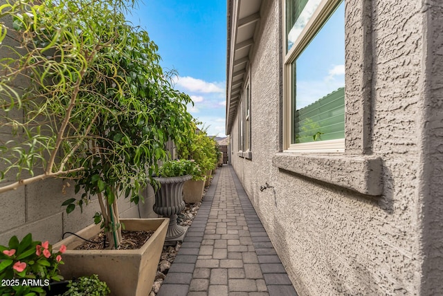 view of property exterior featuring fence and stucco siding