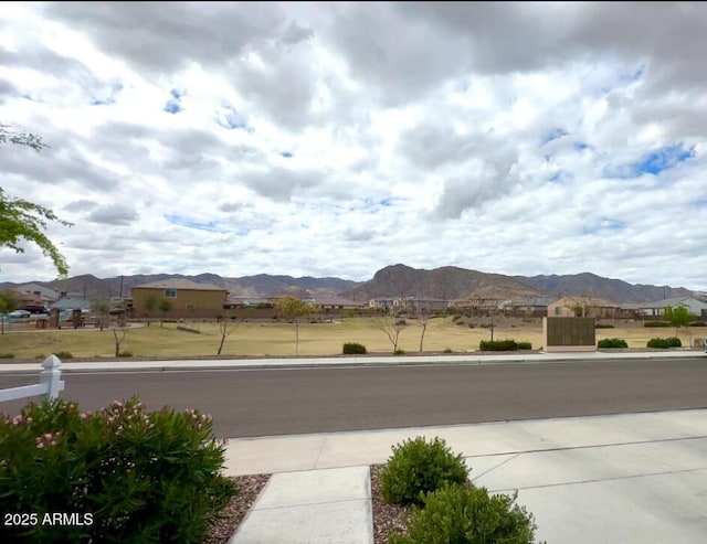 view of street featuring a mountain view and sidewalks