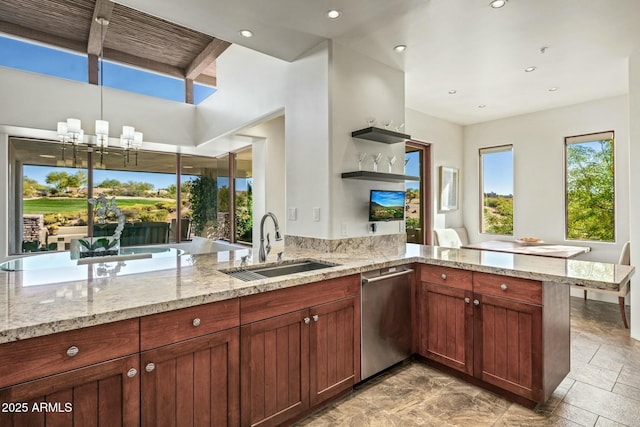 kitchen with light stone counters, dishwasher, sink, and kitchen peninsula