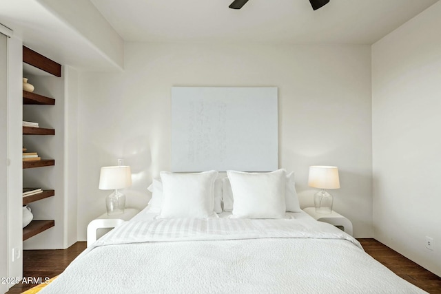 bedroom with ceiling fan and dark hardwood / wood-style flooring