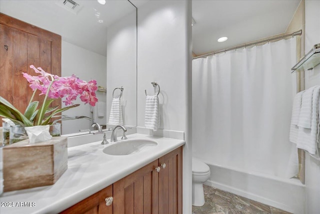 full bathroom with shower / bath combination with curtain, vanity, and toilet