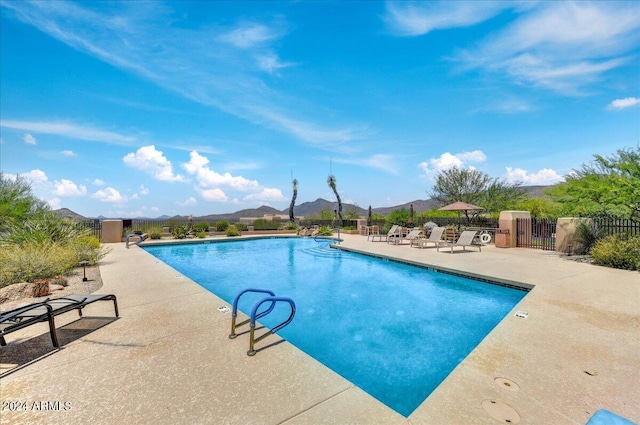 view of pool with a mountain view and a patio area