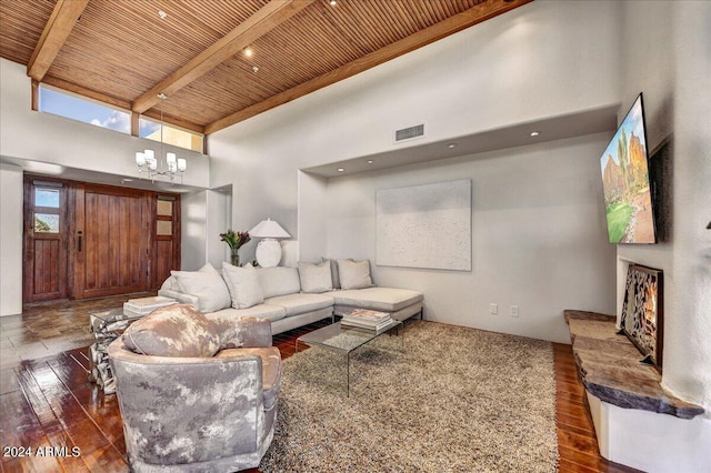 living room with wood ceiling, dark hardwood / wood-style flooring, a notable chandelier, a towering ceiling, and beam ceiling