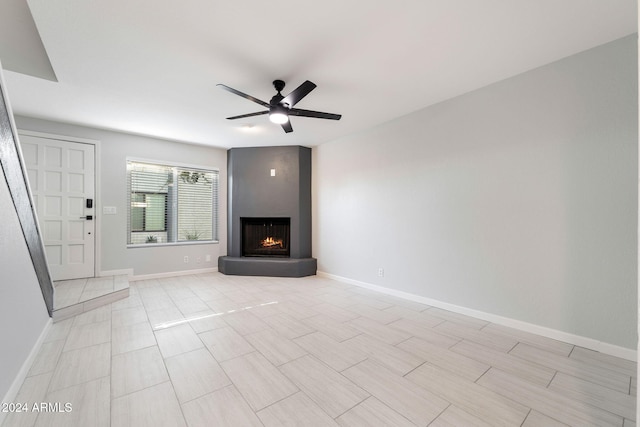 unfurnished living room with ceiling fan